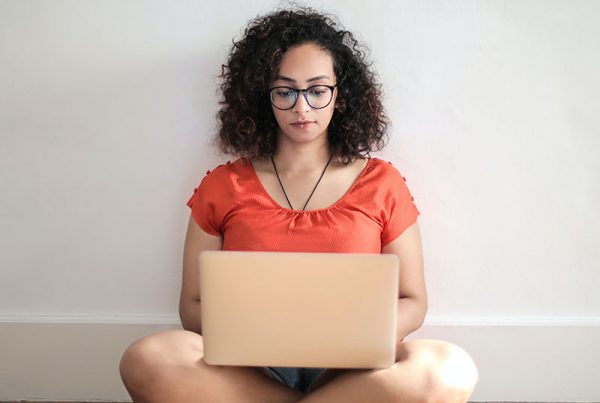 girl with laptop sitting on floor