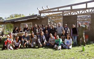 Tribu de la Tierra group in front of building under construction
