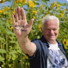 smiling man with #MoveTheDate hand