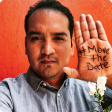 man with #MoveTheDate hand