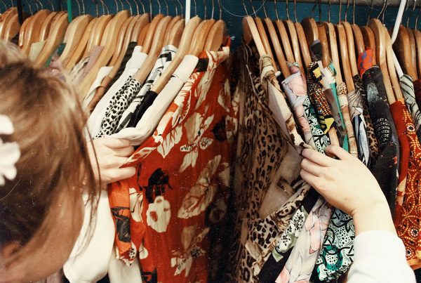 woman looking at clothes on rack