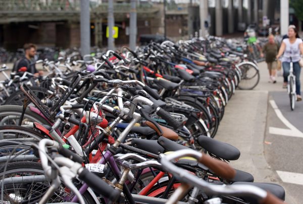 row of parked bicycles near street