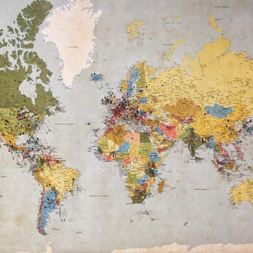 world map with pins on it