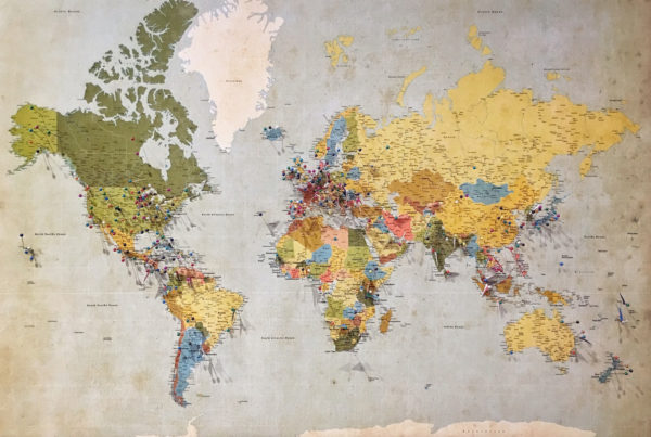 world map with pins on it